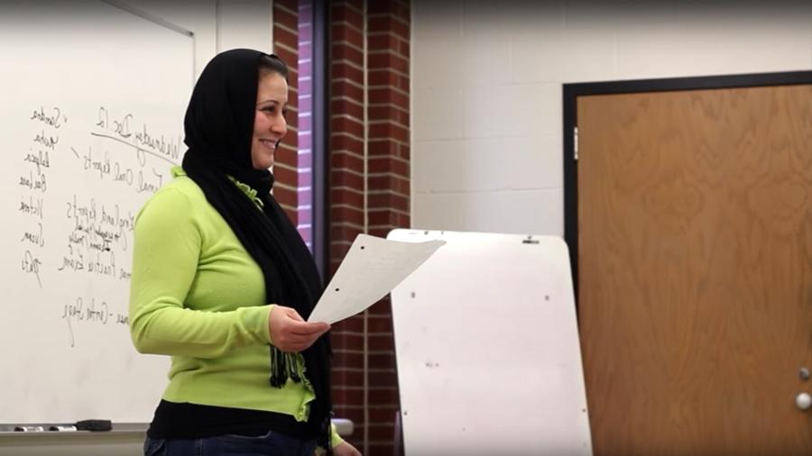 woman with hijab giving class presentation